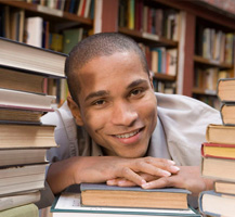 Young man in library with books
