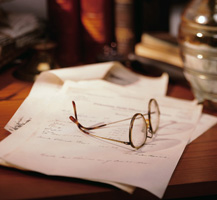 Pair of eye glasses on top of papers