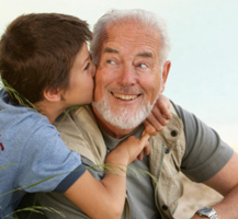 Boy hugging his grandfather